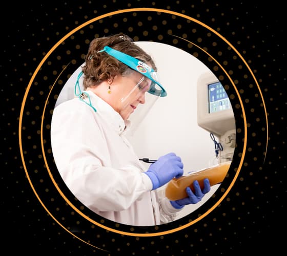 BioLife healthcare professional working by a plasmapheresis machine.